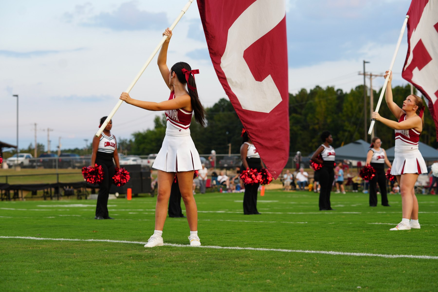 Caledonia's cheerleaders wave the big C flags on the field
