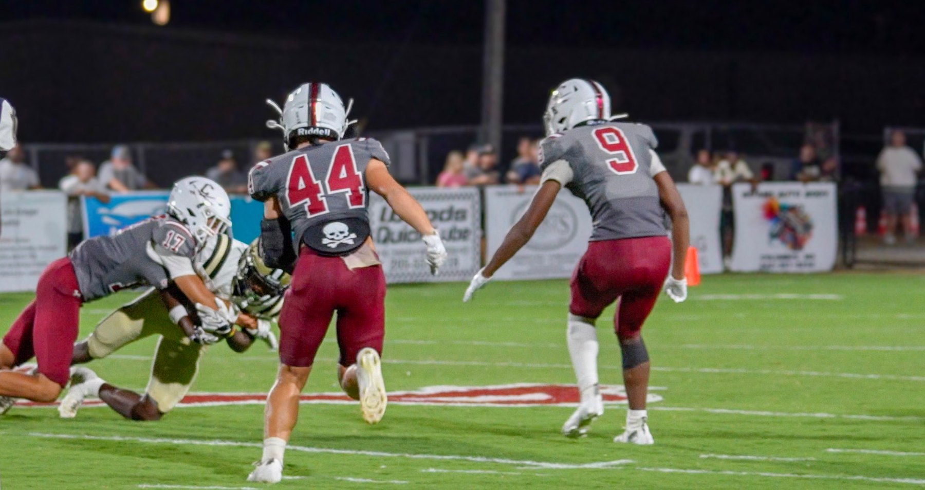 A Caledonia defender closes in as a teammate brings Amory's ball carrier down