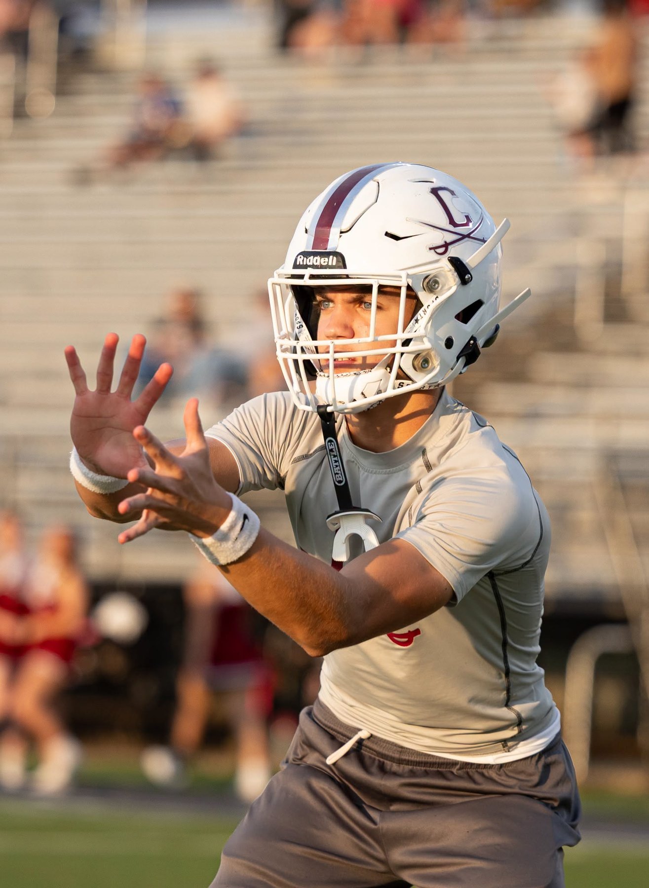 A Caledonia player reaches to catch a pass in warm-ups