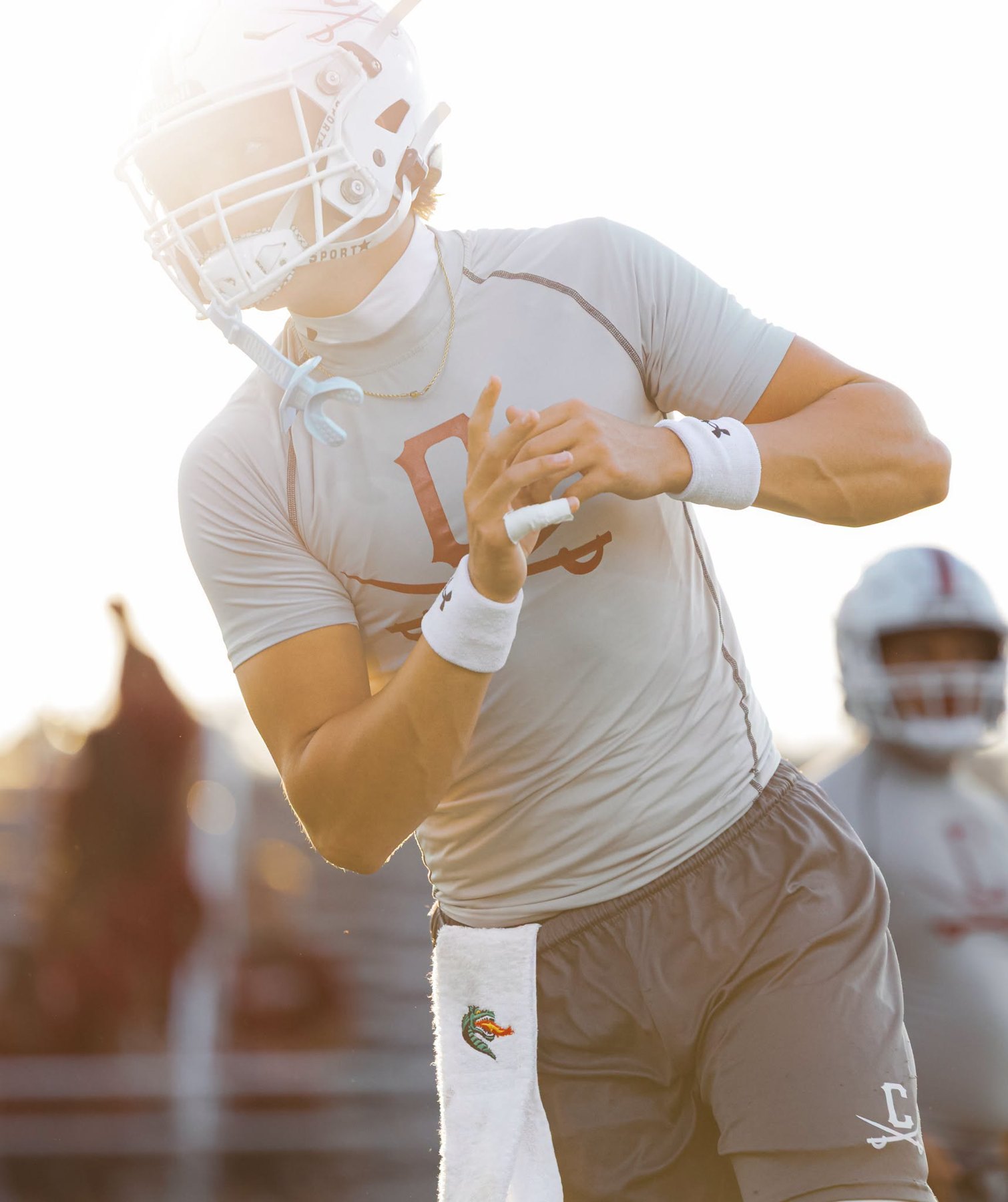 A Caledonia player warms up in the evening sun before the game