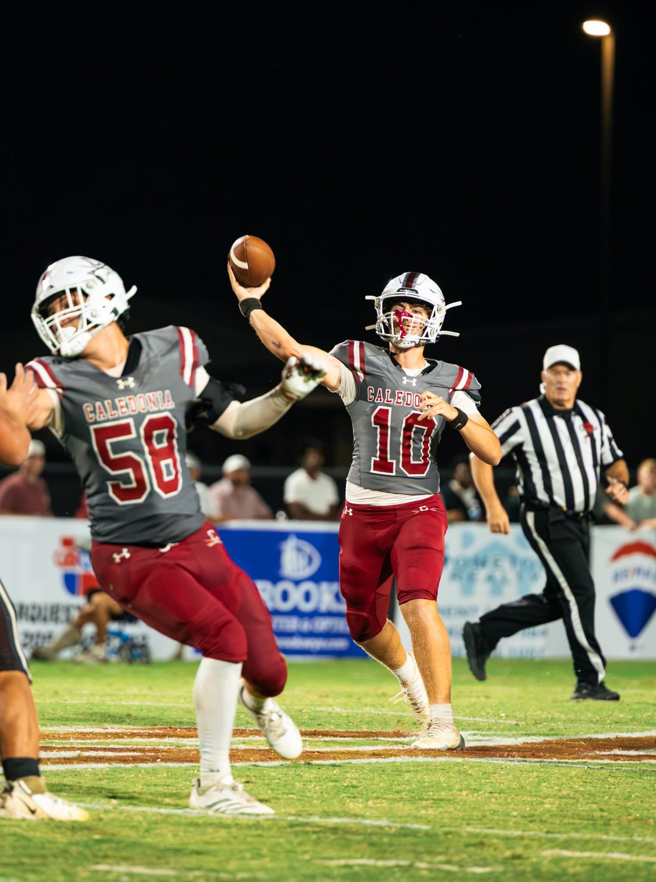 Caledonia's quarterback throws behind a block against East Webster