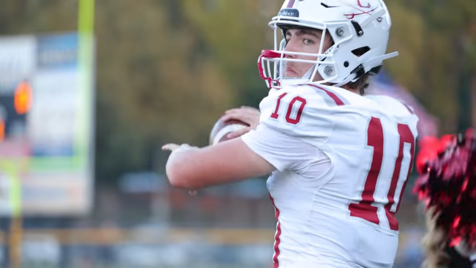 Caledonia's quarterback looks downfield, ball cocked to throw
