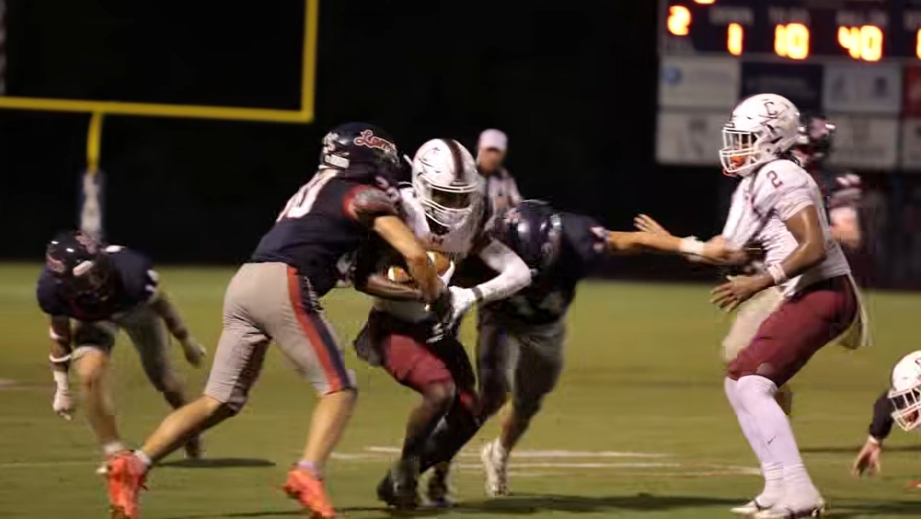 A Caledonia ball carrier pushes through Lamar's defenders