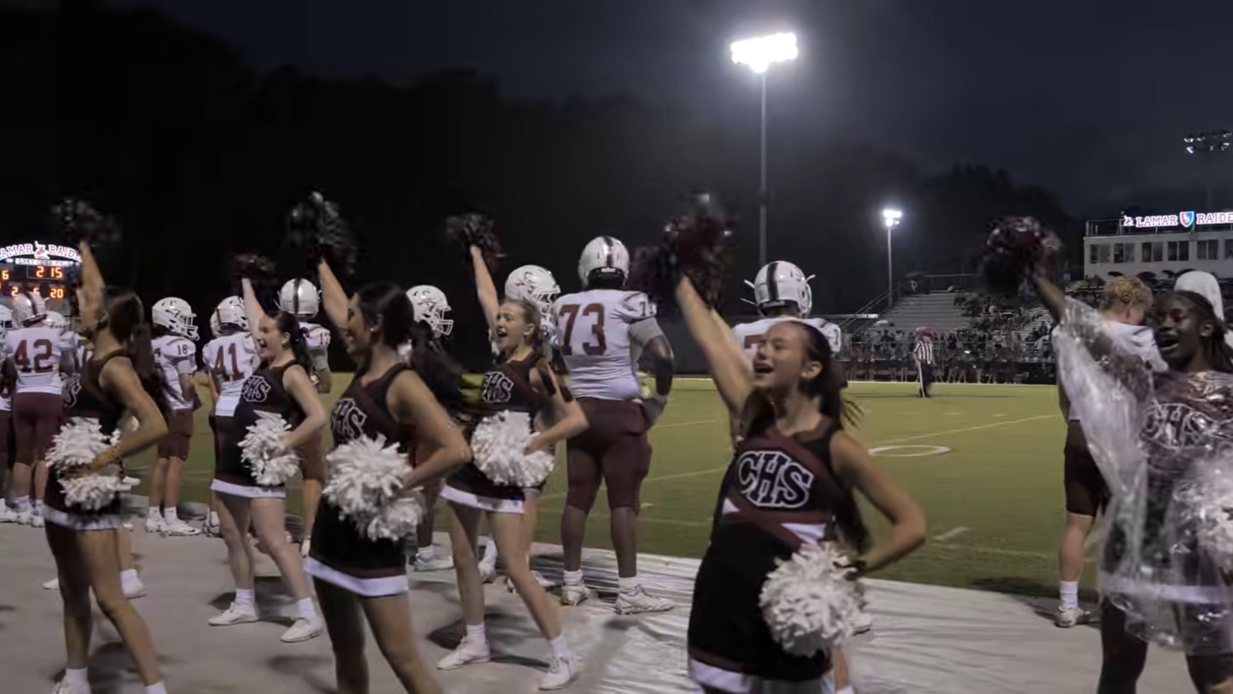 Caledonia's cheerleaders celebrate on the sideline under the lights at Lamar